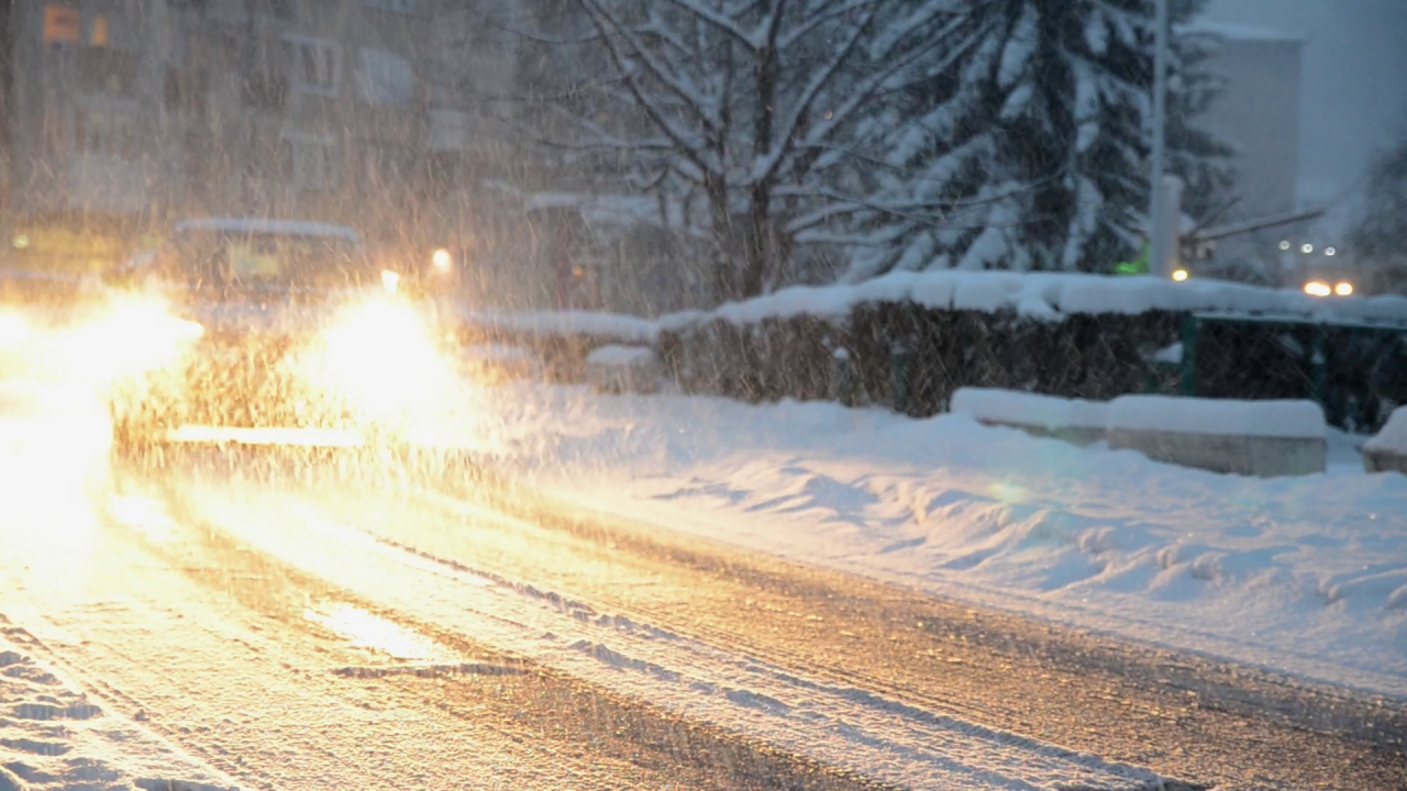 Videoblocks cars on winter ice road snow falling on cars in the city driving on a snow storm hjyxrn qf thumbnail full01