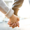 Couple holding hands at arch du triomphe