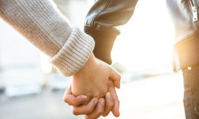 Couple holding hands at arch du triomphe
