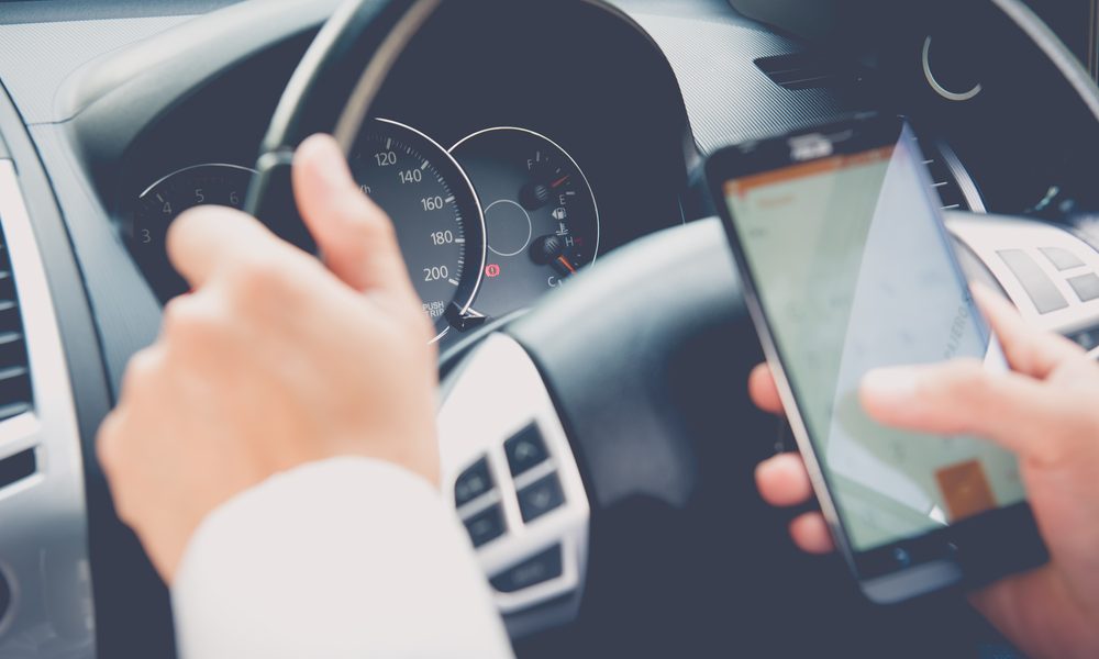 Hand,Using,Phone,Sending,A,Text,While,Driving,To,Work