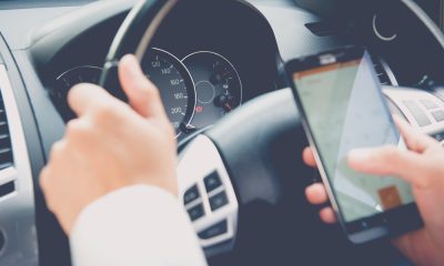 Hand,Using,Phone,Sending,A,Text,While,Driving,To,Work